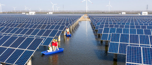 Power workers inspect photovoltaic power generation facilities at a 35-MEGAwatt "fish-light complementary" photovoltaic power station in Binhai, Jiangsu, March 15, 2022