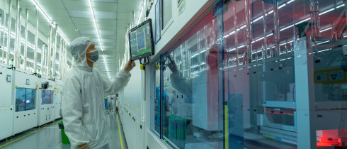 A worker produces photovoltaic cells at an energy Company's cell production workshop in Hefei, East China's Anhui Province