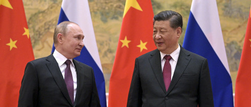Chinese President Xi Jinping, right, and Russian President Vladimir Putin talk to each other during their meeting in Beijing, China, Friday, Feb. 4, 2022. 