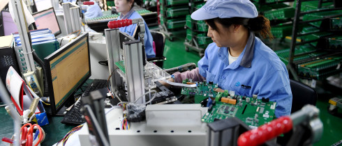 Workers work on a module testing production line in Hebei province, China