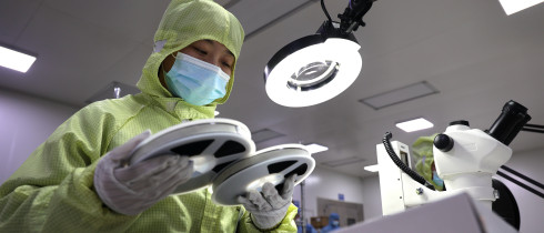 A worker produces semiconductors at a workshop of a semiconductor manufacturer in Binzhou, East China's Shandong Province.