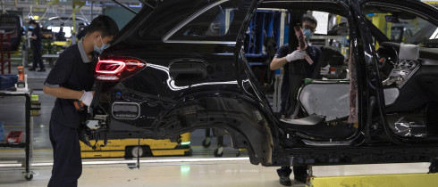 Workers assemble cars at a Beijing Benz Automotive Co. Ltd factory, a German joint venture company for Mercedes-Benz, in Beijing