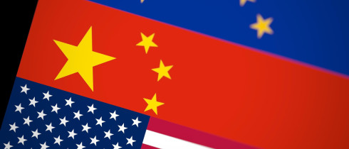 Blurred USA, China and EU flags together on black background