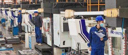 Workers produce slitting machine parts at Qingdao Kaisheng CNC Equipment Co., LTD., in Qingdao, Shandong province, China, November 28, 2024