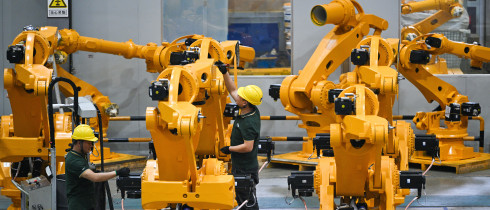 Workers assemble industrial robots at a robot manufacturer in Nanjing city in east China's Jiangsu province.