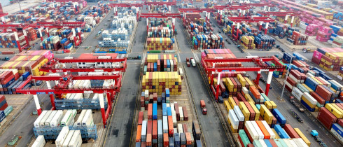 Vehicles are loading containers at Qingdao Port Foreign Trade Container Terminal in Shandong Province, China
