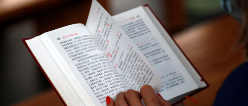 Woman reading a chinese bible.