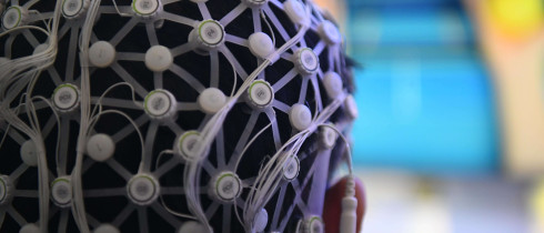 Person demonstrating a motor imagery brain-computer interface rehabilitation training system.