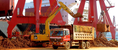-An excavator loads a truck with rare earth on a quay at the Port of Lianyungang in Lianyungang city, east Chinas Jiangsu province, 10 March 2013.