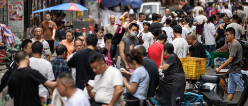 : A view of the street, where recruitment takes place in Datang Village, functions as a central labor market for the garment industry in urban villages in Guangzhou, China on July 11, 2025