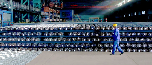 A technician inspects the quality of steel products to be delivered, Zhangjiakou City, Hebei Province, China
