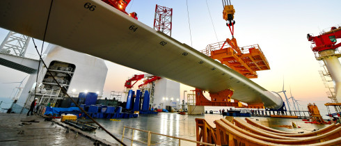 This photo taken on Jan. 13, 2026 shows one of the turbine blades being hoisted at the construction site of a 20-megawatt offshore wind turbine unit in the coastal waters of southeast China's Fujian Province. 